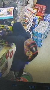 Armed robbery suspect with multi-colored backpack